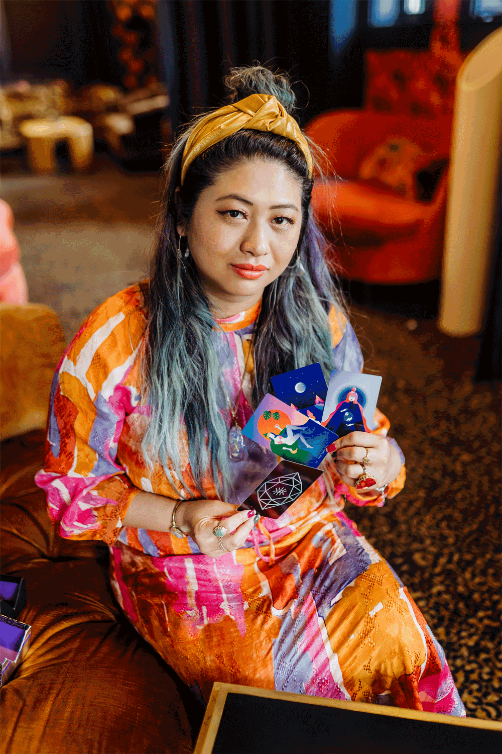 Grace Duong holding tarot cards